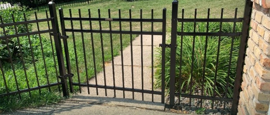 Single walk gate hung on a stained cedar privacy fence